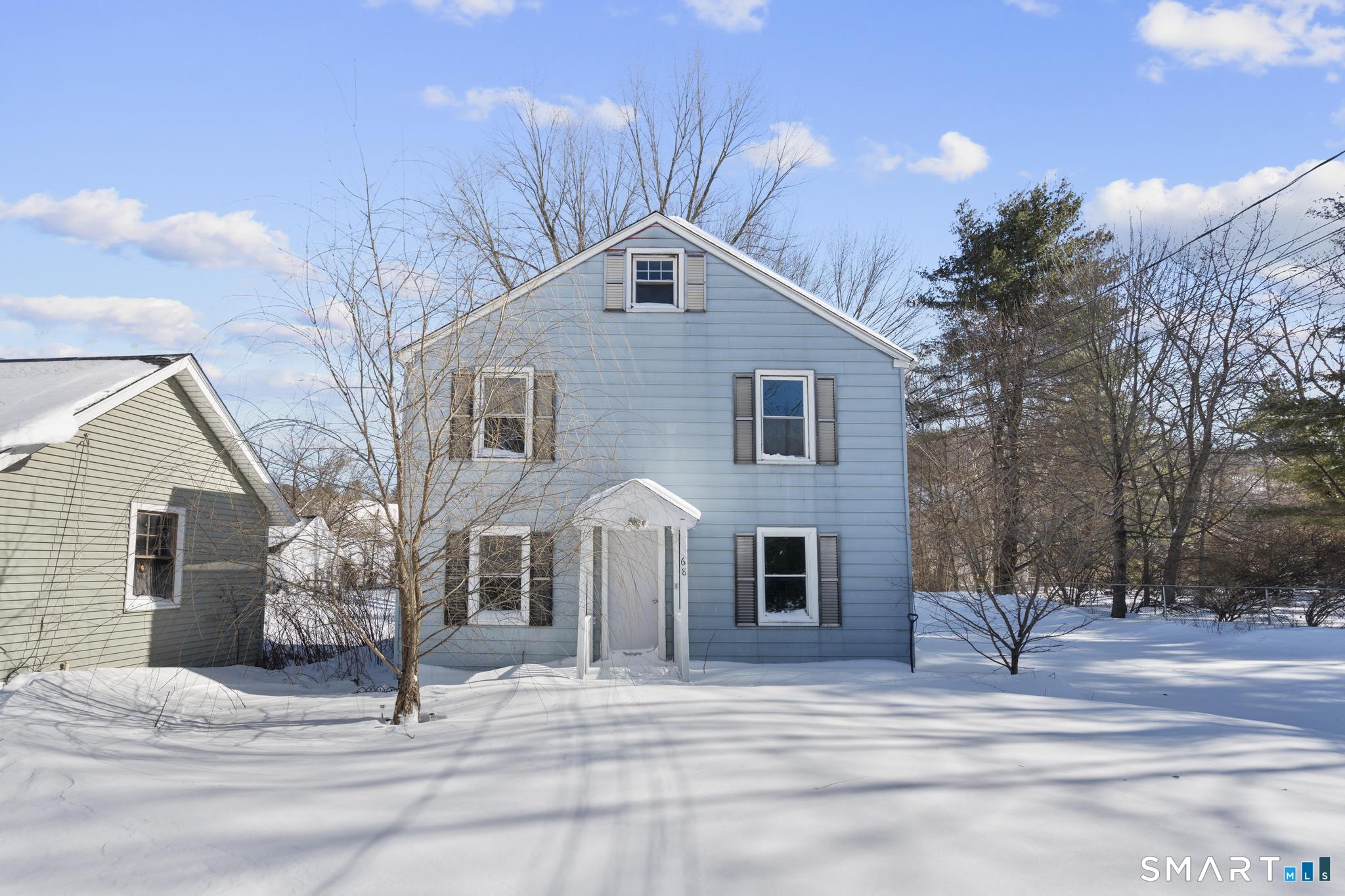 a view of a house with a yard and garage