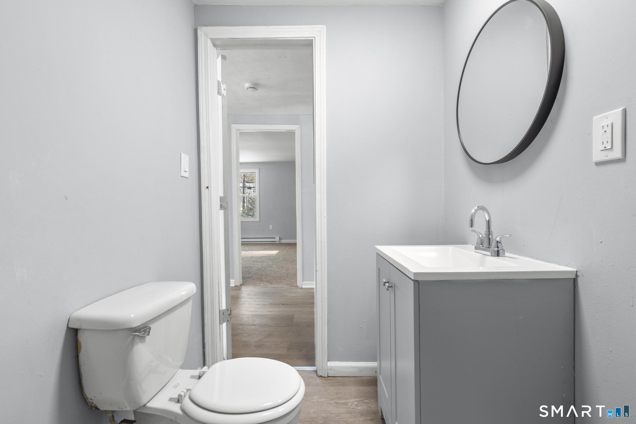 68 Thomaston Road Litchfield, CT 06791 - Photo 11 of 18 a white toilet sitting next to a bathroom sink