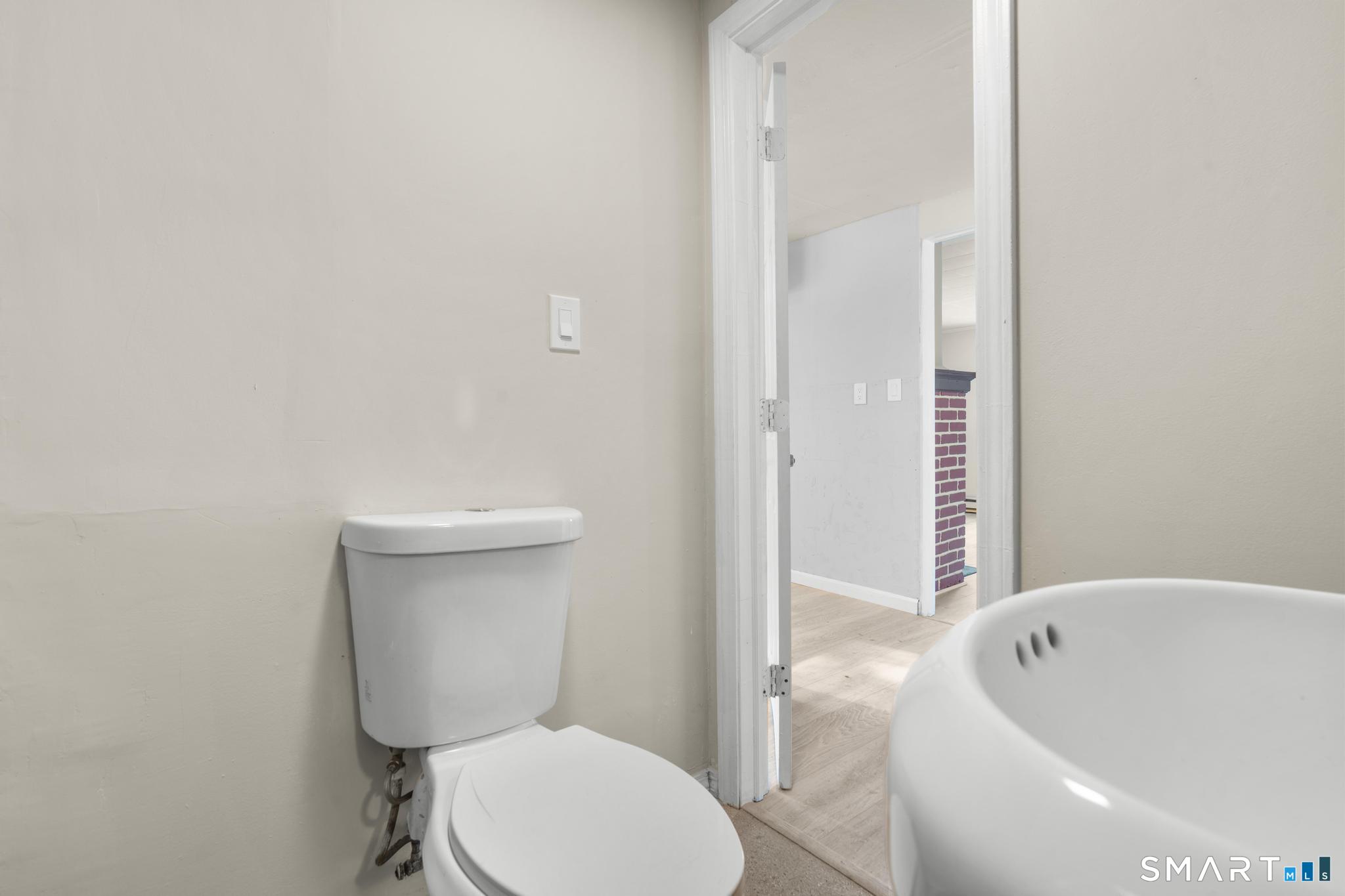 68 Thomaston Road Litchfield, CT 06791 - Photo 13 of 18 a white toilet sitting next to a bathroom sink