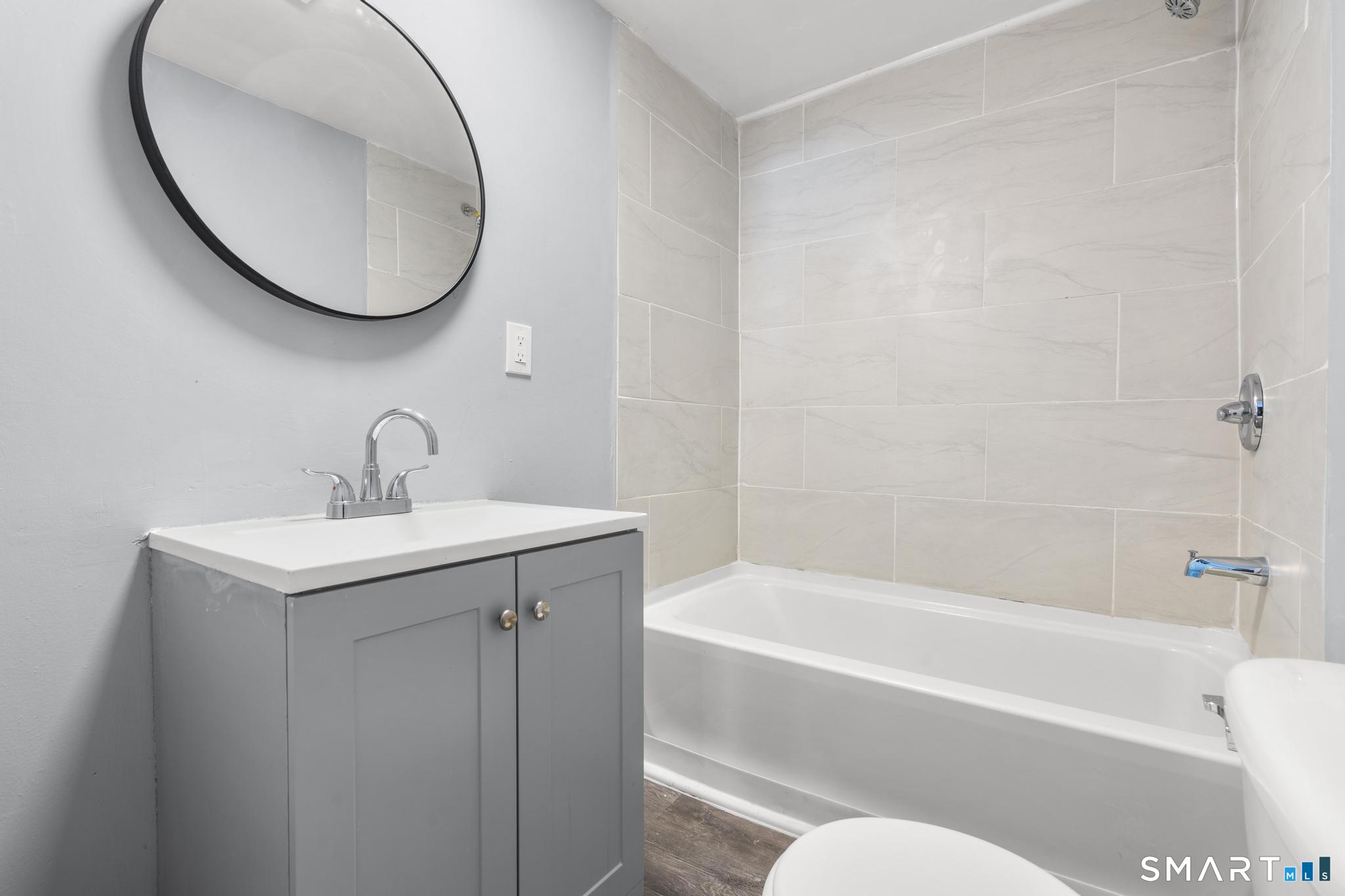 68 Thomaston Road Litchfield, CT 06791 - Photo 3 of 18 a bathroom with a sink and a mirror