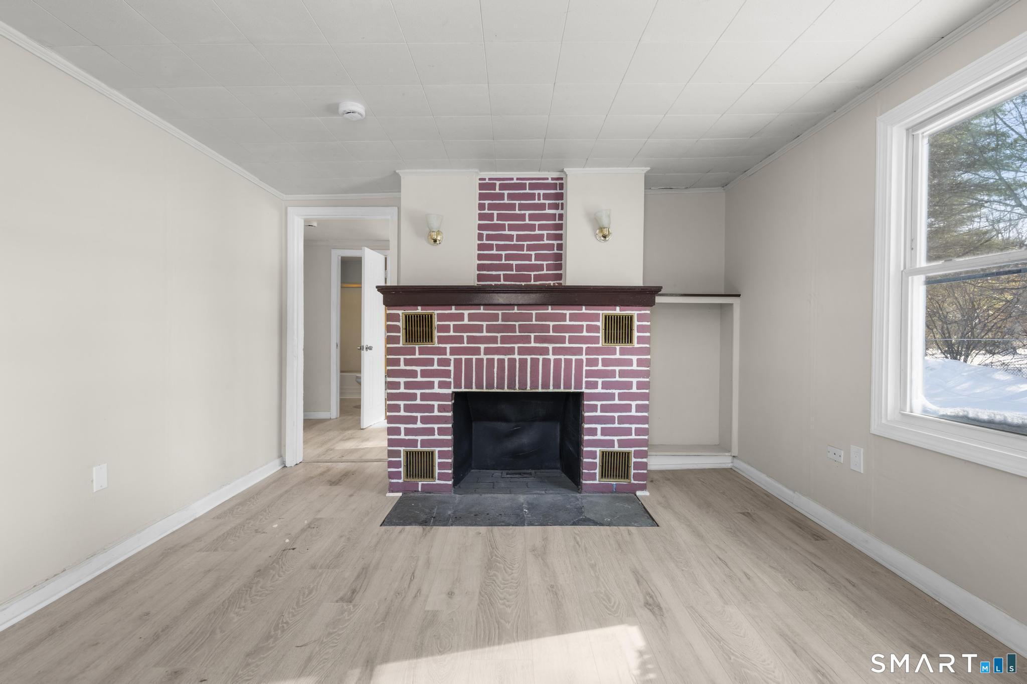 68 Thomaston Road Litchfield, CT 06791 - Photo 4 of 18 a living room with a fireplace and wooden floor