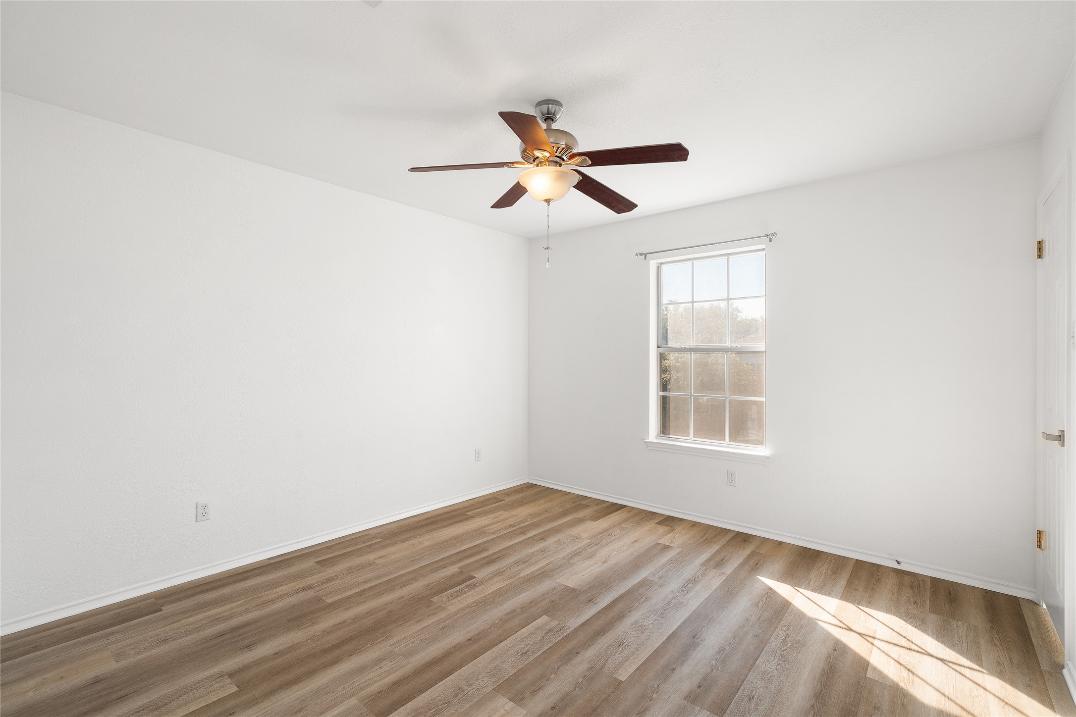 206 River Down Road Georgetown, TX 78628 - Photo 23 of 39 Spacious room featuring wood-finish flooring, white walls, and a ceiling fan with integrated lighting