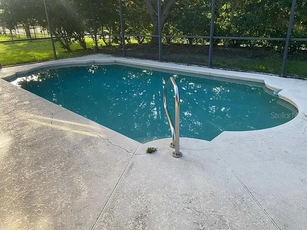 a view of a wooden fence with a yard
