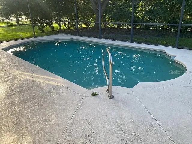 a view of a wooden fence with a yard