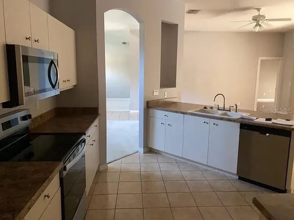 a kitchen with a sink stove and refrigerator