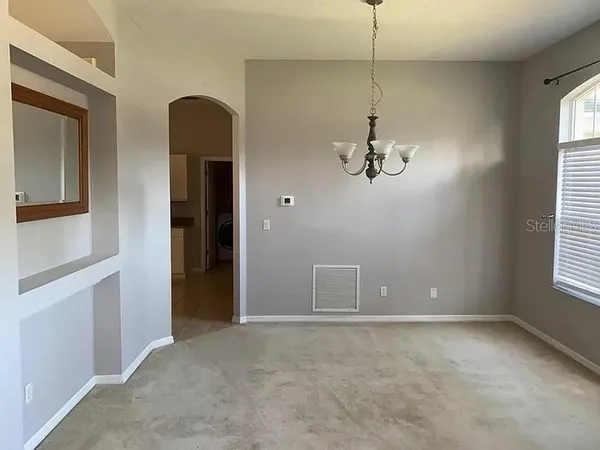 a view of a room with a windows and cabinet