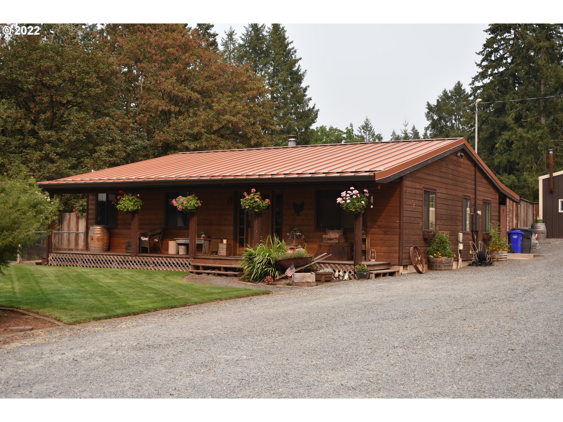 19477 South Rockney Road Colton, OR 97017 - Photo 1 of 25 a patio with a table and chairs under an umbrella