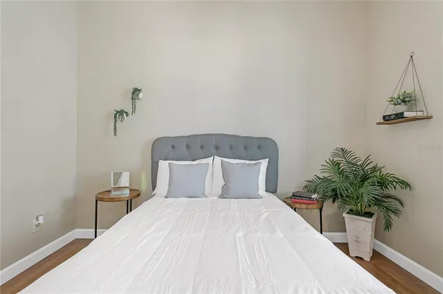 a bedroom with a bed and a potted plant
