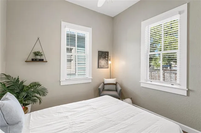 a bedroom with a bed and a window