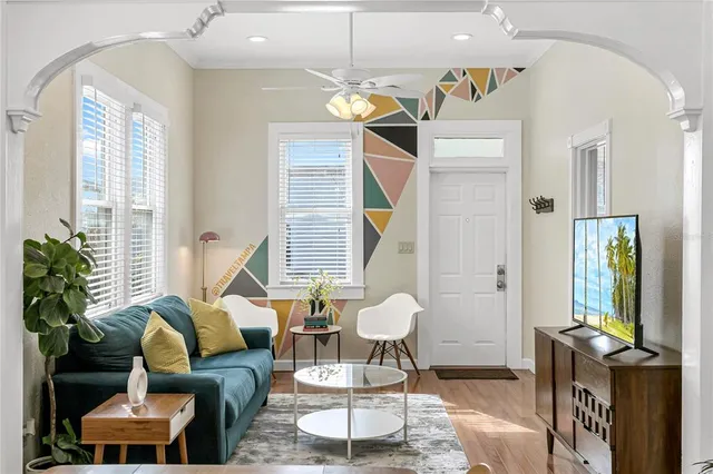 a living room with furniture and a chandelier