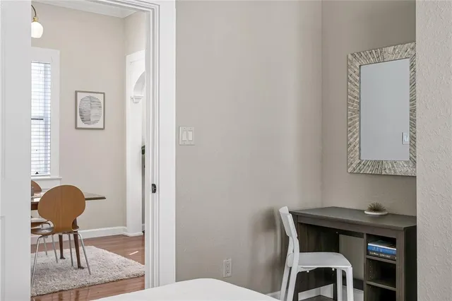 a workspace room with furniture and wooden floor