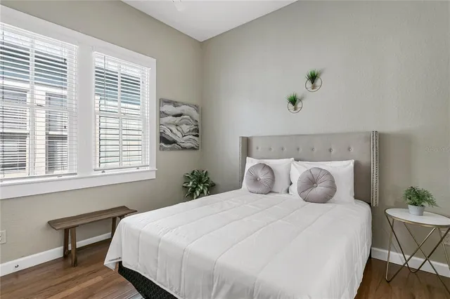 a bedroom with a bed and a window