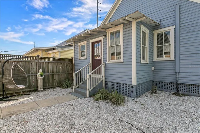 a view of a house with a backyard