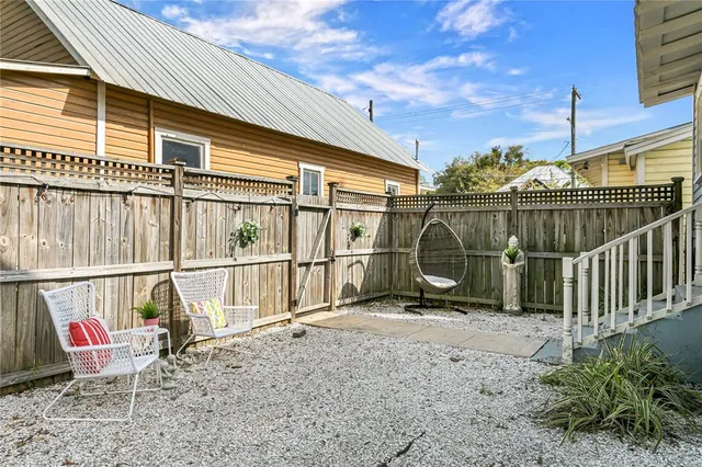 a view of roof deck with a barbeque and wooden fence