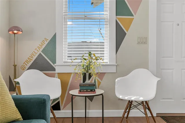 a view of a room with furniture and a window