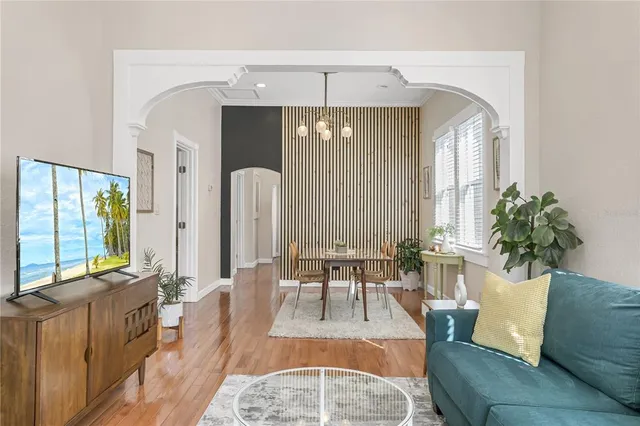 a living room with furniture and a chandelier