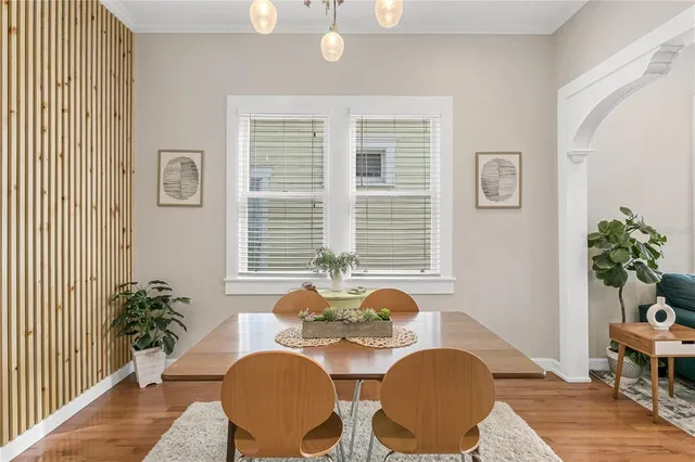 a dining room with furniture and wooden floor