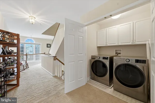 a view of a hallway with washer and dryer