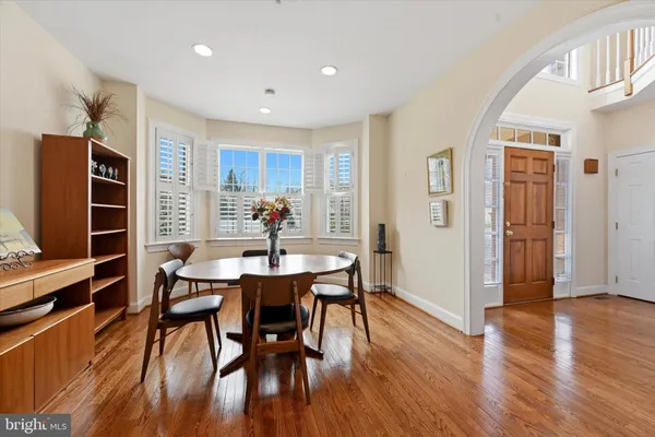 a view of a dining room with furniture window and wooden floor