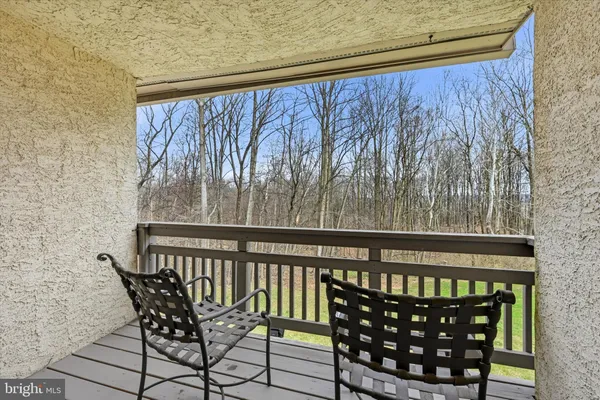 a view of a chairs and table in the balcony