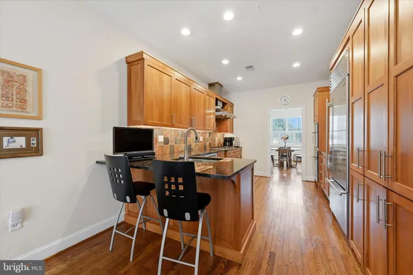 a living room with furniture a wooden floor and a flat screen tv