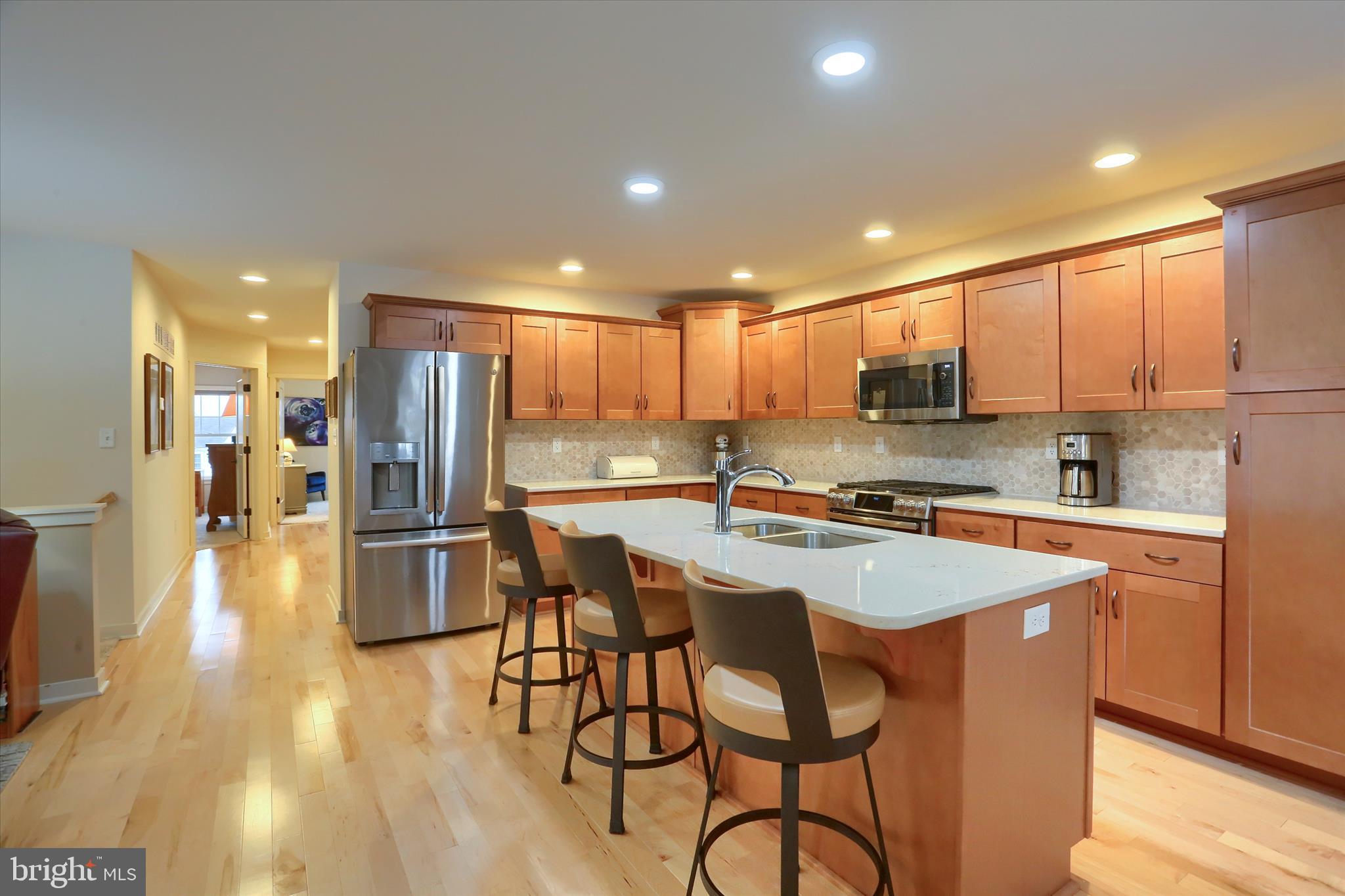 6238 Overview Lane Harrisburg, PA 17111 - Photo 12 of 34 a kitchen with stainless steel appliances granite countertop a table chairs sink refrigerator and microwave