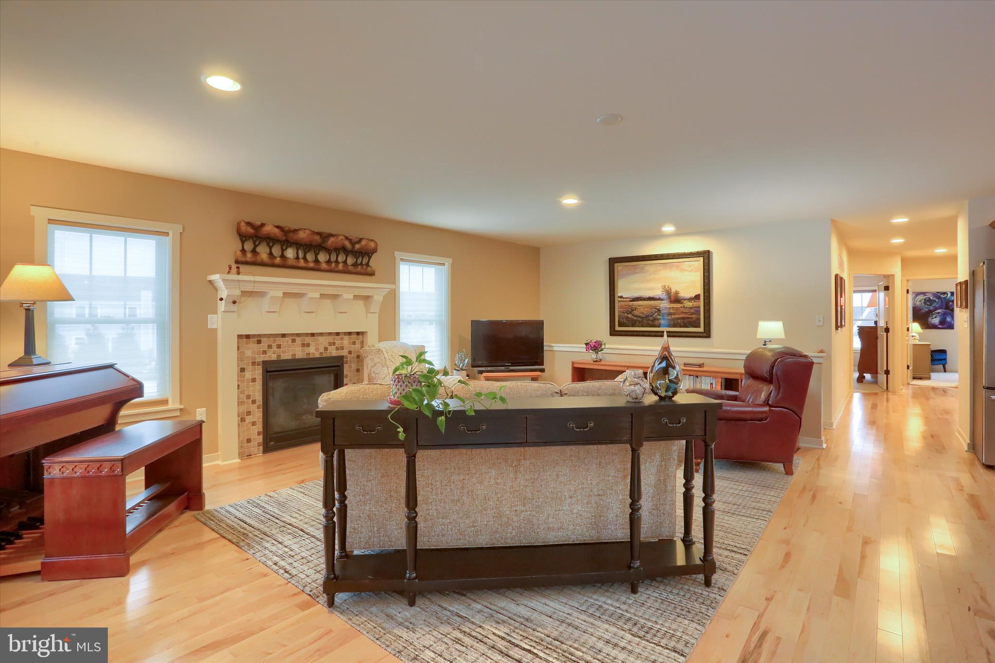 6238 Overview Lane Harrisburg, PA 17111 - Photo 4 of 34 a living room with furniture a fireplace and a dining table with wooden floor