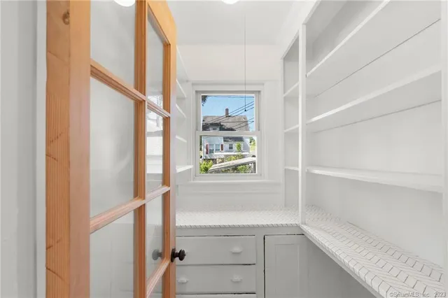 a bathroom with a window and a shower