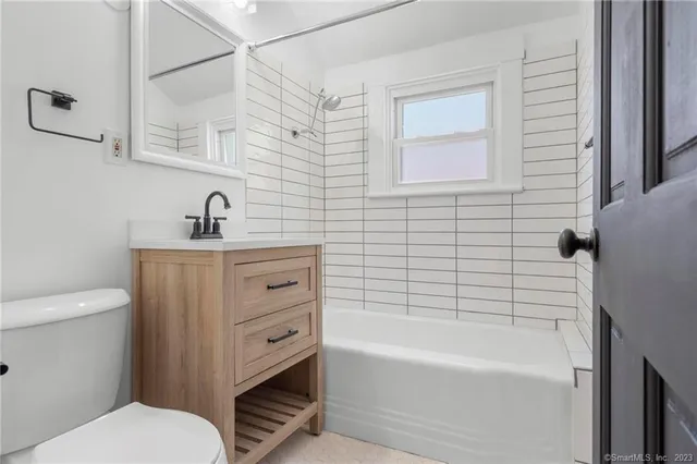 a bathroom with a sink a toilet and bathtub