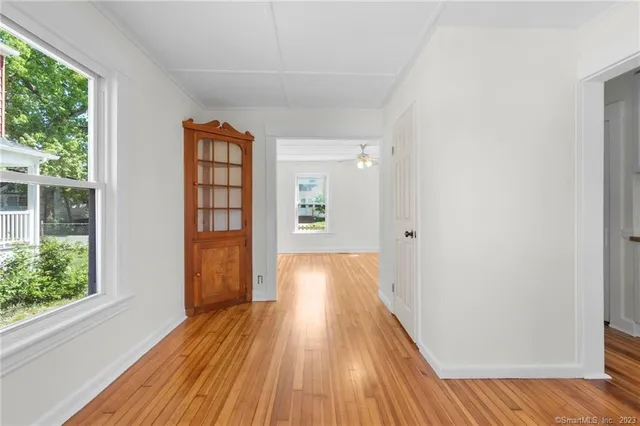 a view of hallway with wooden floor and stairs