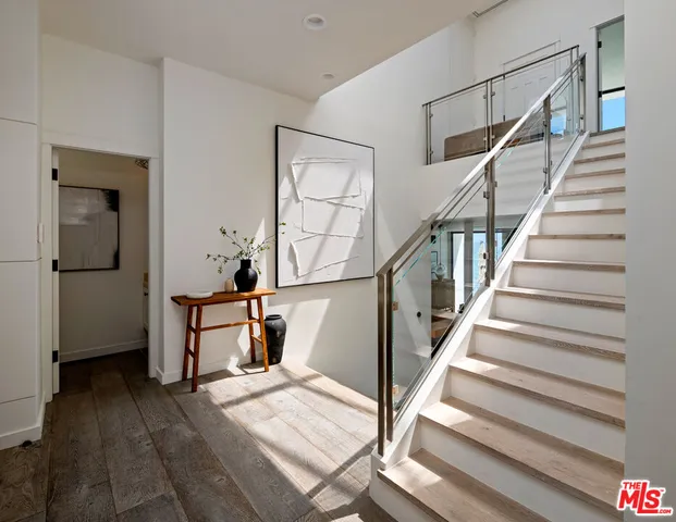 a view of entryway and hall with wooden floor