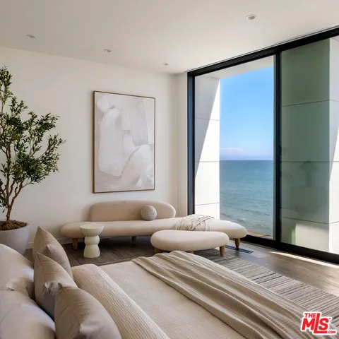 a bedroom with furniture and a potted plant