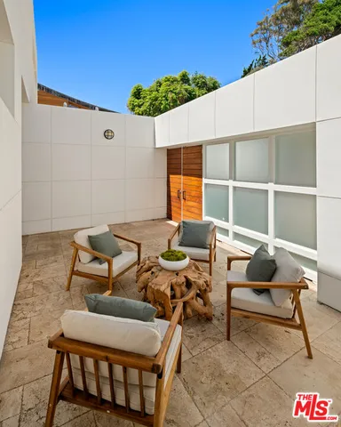 a backyard of a house with table and chairs