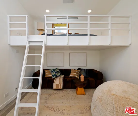 a bathroom with a double vanity sink a toilet and shower