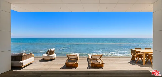 a view of a lake with table and chairs