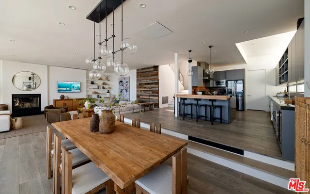 a living room with fireplace furniture and a wooden floor