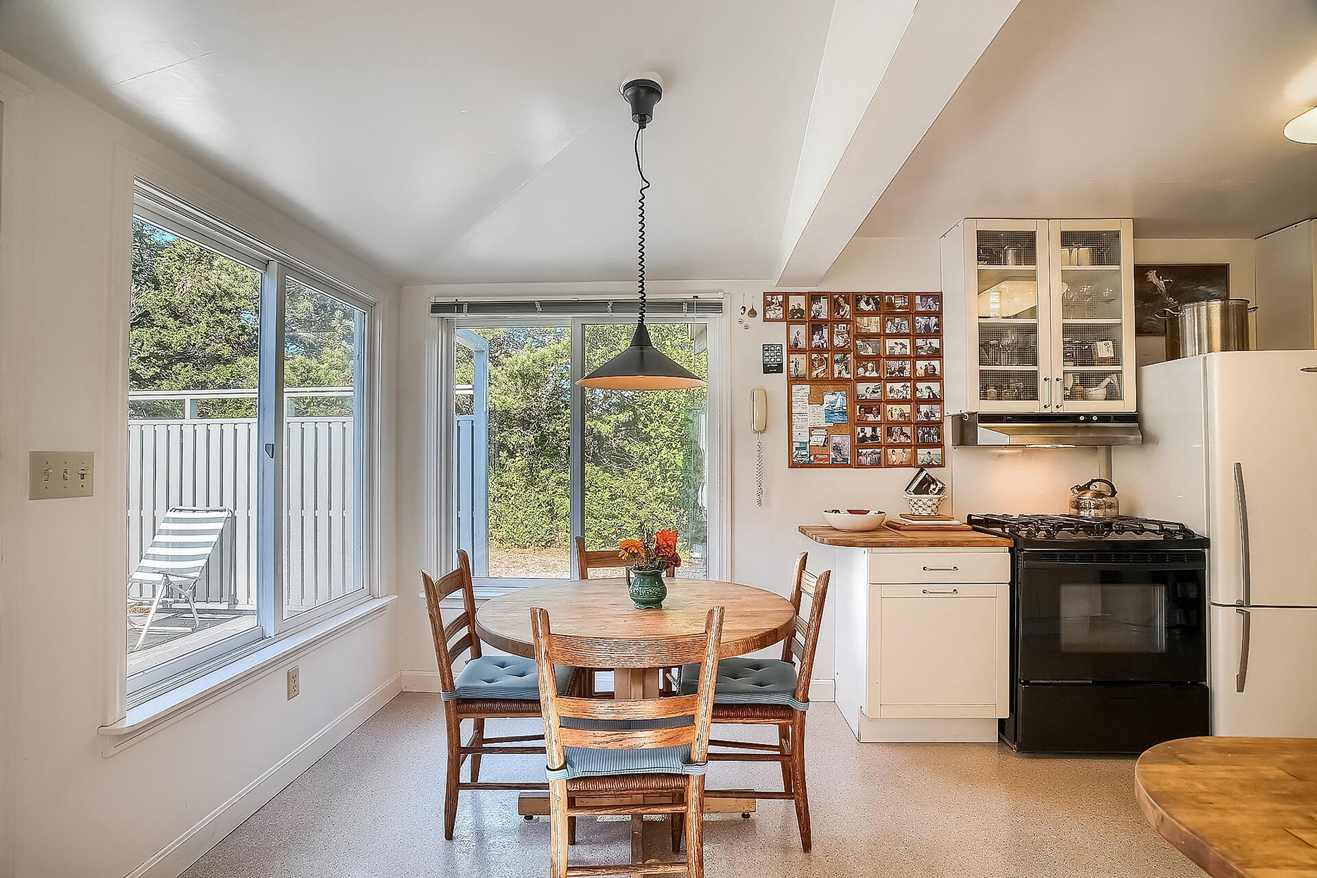 8 Standish Road Orleans, MA 02653 - Photo 11 of 28 a dining room with stainless steel appliances granite countertop a stove a refrigerator a kitchen island a dining table and chairs with wooden floor