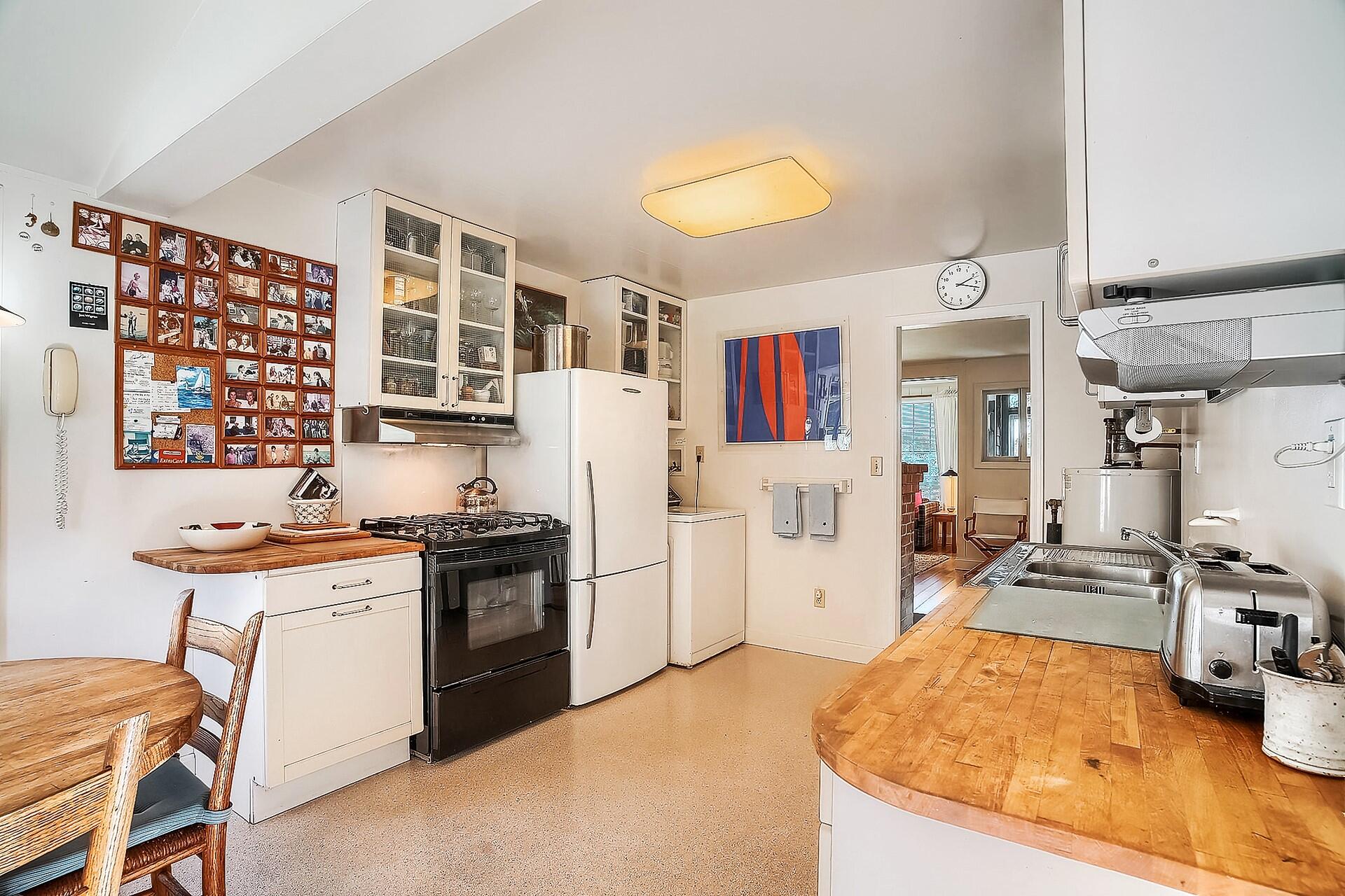 8 Standish Road Orleans, MA 02653 - Photo 9 of 28 a kitchen with a stove a refrigerator and wooden floor