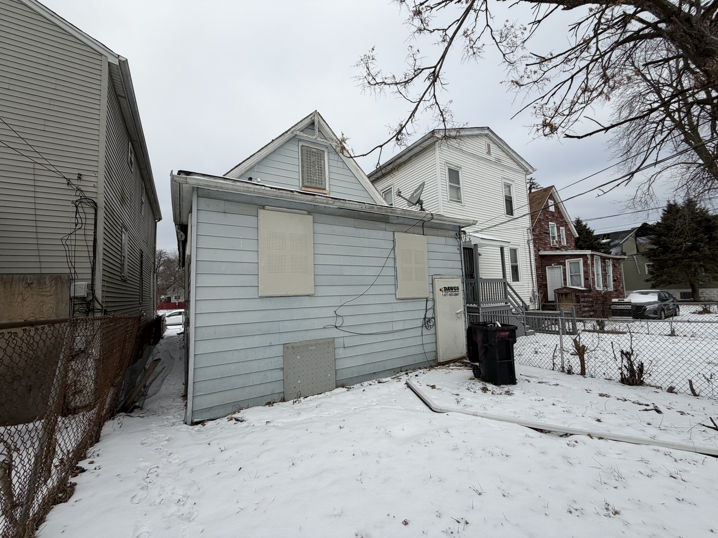 10623 South Perry Avenue Chicago, IL 60628 - Photo 2 of 14 a view of a house with a yard covered in snow