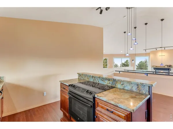 a kitchen with granite countertop a stove a sink and a granite counter tops