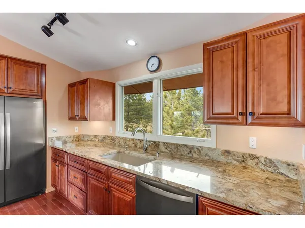 a kitchen with a window a sink and a counter top space