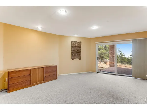 a view of a big room with windows and entryway