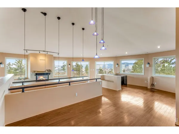 a open kitchen with stainless steel appliances granite countertop a refrigerator a sink dishwasher and white cabinets with wooden floor