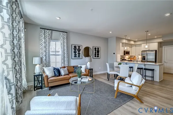 a living room with furniture kitchen and a table