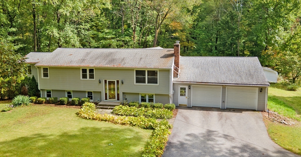 205 Beaman Road Sterling, MA 01564 - Photo 1 of 41 a front view of a house with a yard