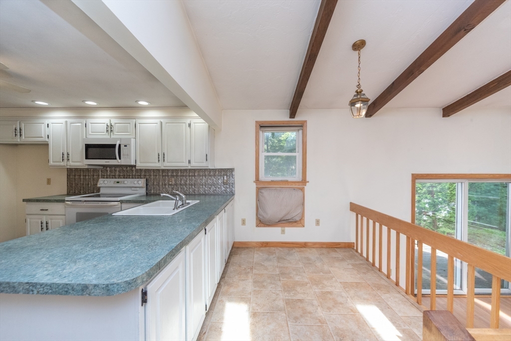 205 Beaman Road Sterling, MA 01564 - Photo 13 of 41 a kitchen with stainless steel appliances granite countertop a sink stove and cabinets