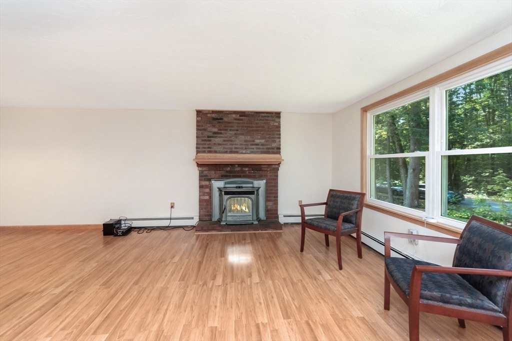 205 Beaman Road Sterling, MA 01564 - Photo 17 of 41 a living room with furniture and a fireplace