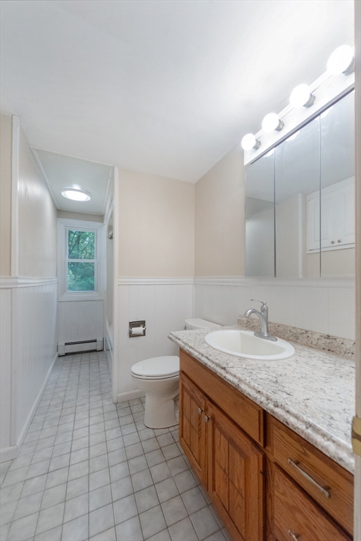 205 Beaman Road Sterling, MA 01564 - Photo 18 of 41 a bathroom with a granite countertop sink and mirror with toilet