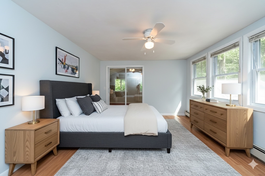 205 Beaman Road Sterling, MA 01564 - Photo 20 of 41 a bedroom with a large bed and a chandelier