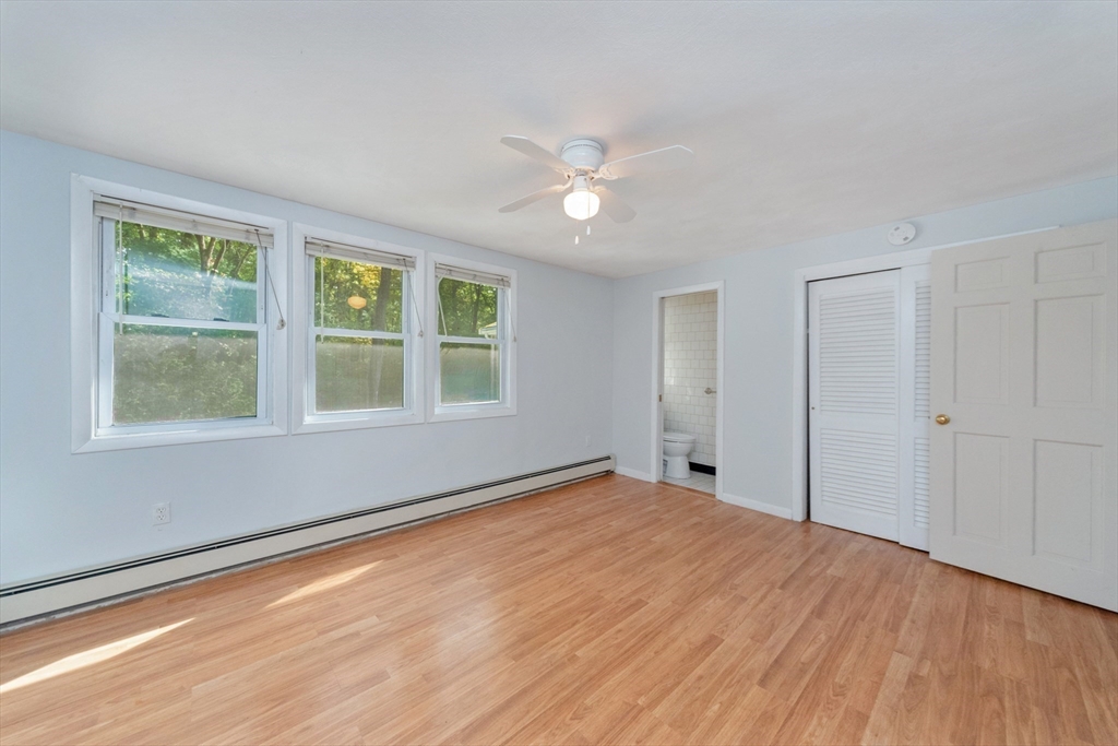 205 Beaman Road Sterling, MA 01564 - Photo 21 of 41 a view of empty room with wooden floor and fan
